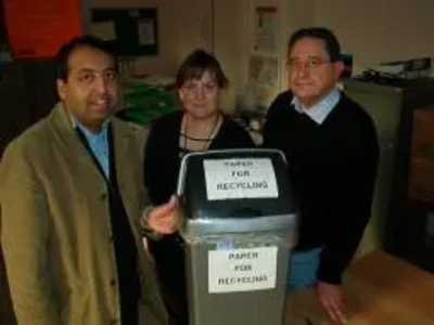 Zuffar Haq, Cllr Debbie Almey and Jeff Stephenson recycle paper at New Walk Centre.