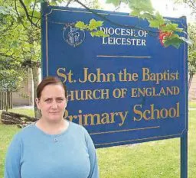 Debbie Almey outside St John the Baptist School