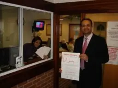 Parmjit Singh Gill MP talks to a receptionist in a doctor's surgery in Evington