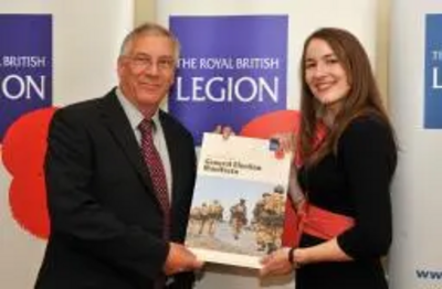 Peter Coley signs the pledged to do his bit for the British Armed Forces family